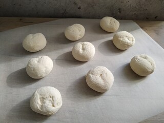Fototapeta na wymiar Nine pieces of dough on the table