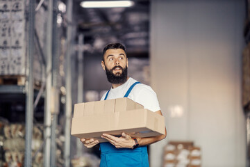 A storage worker relocating boxes with goods.