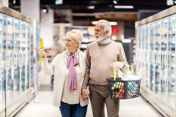 Senior couple shopping at supermarket.