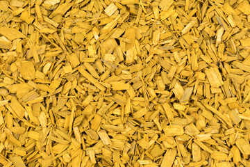 yellow wood bark mulch chips closeup background