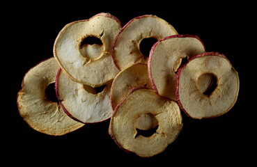Dried slices apple, chips isolated on black, top view