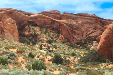 Landscape Arch, the longest of arches in Arches National Park, Utah, USA. Devil's Garden trail. Hiking in the American southwest. Geological formations in Utah desert. Sandstone cliffs and bridges.