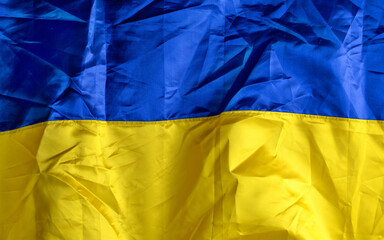 Yellow and blue Ukrainian satin flag. Abstract texture