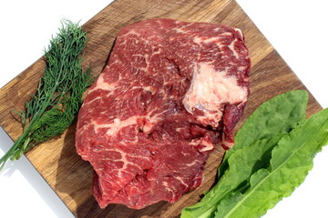 Fresh raw meat lies on a cutting board.