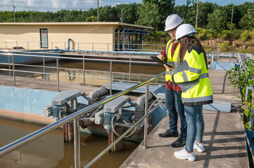 Environmental engineers work at wastewater treatment plants,Water supply engineering working at Water recycling plant for reuse,Technicians and engineers discuss work together.