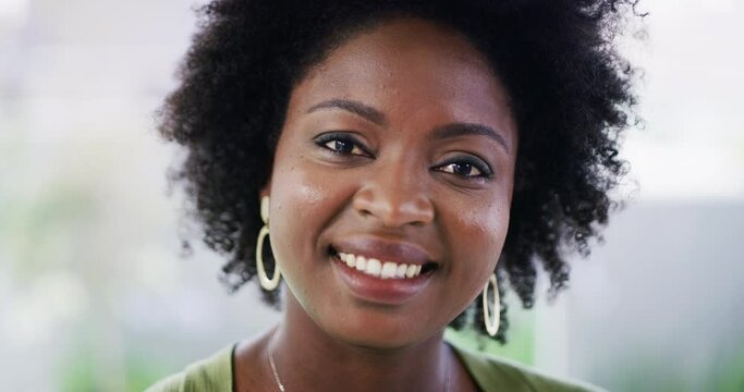 Portrait of one confident african american businesswoman smiling while standing in an office. Face of ambitious black entrepreneur and determined leader ready for success in her startup agency