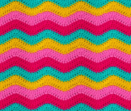 Seamless knitted pattern in the form of zigzags is crocheted with bright multi-colored threads. Acrylic baby yarn. African style.