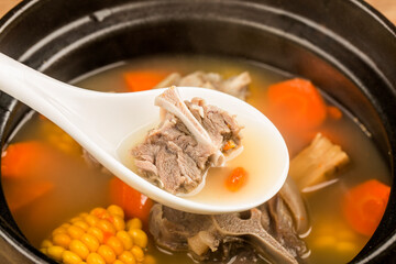 Stewed mutton soup with corn and carrot