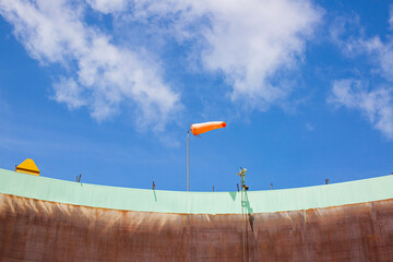 Windsock indicator of wind on tank chemical cone indicating wind direction and force. Horizontally...