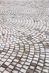 Square stone for paving the surface of the walkway.