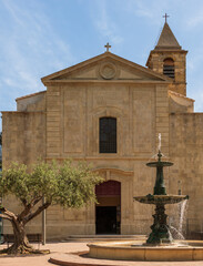 Republic square, Saint Laurent church and its fountain, in Saint Laurent d'Aigouze, in Gard,...