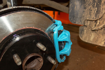 Selective focus of car brake disc for repair. Repair of car brakes in the garage.
