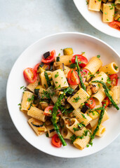 Pasta salad with grilled vegetables, zucchini, eggplant, asparagus and tomatoes.