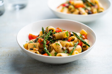 Pasta salad with grilled vegetables, zucchini, eggplant, asparagus and tomatoes.