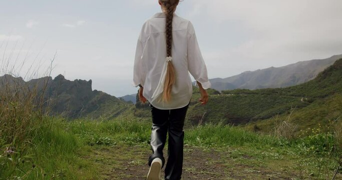 Young woman walks and enjoys the view of Masca Gorge. Tenerife, Canary Islands, Spain