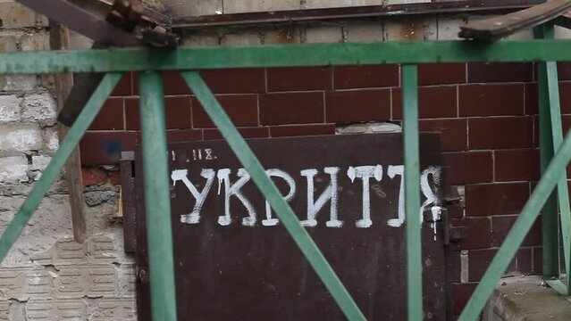 The inscription in Ukrainian language on the doors - shelter. Entrance to the bomb-shelter. Russian Invasion of Ukraine.