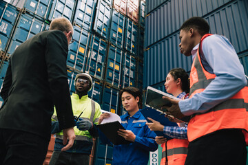 Shipping worker team update information together at the container yard as the background. shipment...