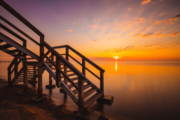 Fototapeta na wymiar Amazing sunrise in small village Mechelinki. Baltic sea bay.