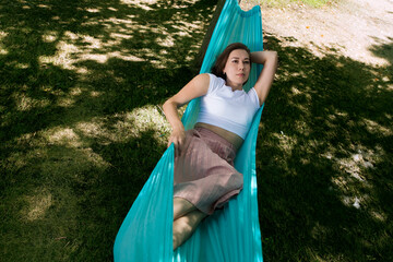 Slow life. Enjoying the little things. spends time in nature in summer. a a woman rests in a hammock the garden on a summer day
