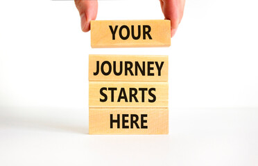 Your journey starts here symbol. Concept words Your journey starts here on wooden blocks on a beautiful white table white background. Business, motivational and your journey starts here concept.