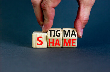 Stigma or shame symbol. Concept words Stigma or Shame on wooden cubes. Businessman hand. Beautiful grey table grey background. Business stigma or shame concept. Copy space.