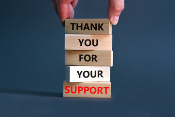 Thank you for support symbol. Concept words Thank you for your support on wooden blocks on a beautiful grey table grey background. Businessman hand. Business and thank you for support concept.