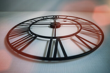 Big round black clock hanging on white wall at home low angle view