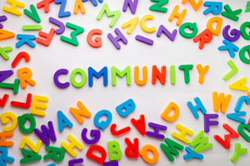 Group of colored letters forming in the center the word "community". Word community formed with colored letters