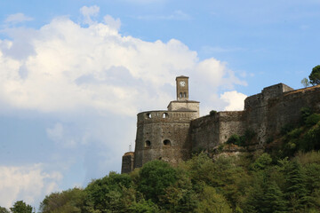 Beautiful view of the Gjirokaster castle clock with a blue sky and white clouds, Albania.