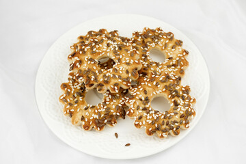 Delicious cookies with sesame seeds and flax. baking according to homemade recipes on a plate top view