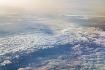 View from the plane on the sky covered with clouds.