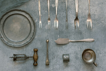 Vintage kitchen utensils on grunge concrete background, top view
