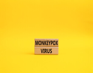 Monkeypox virus symbol. Concept word Monkeypox virus on wooden blocks. Beautiful yellow background. Medicine and Monkeypox virus concept. Copy space