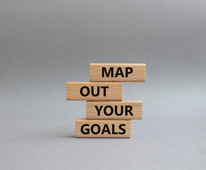 Goals symbol. Wooden blocks with words Map out your goals. Beautiful grey background. Business and 'Map out your goals' concept. Copy space.