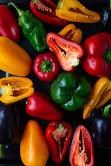Overhead view of ripe red yellow green bell pepper food background whole and slice