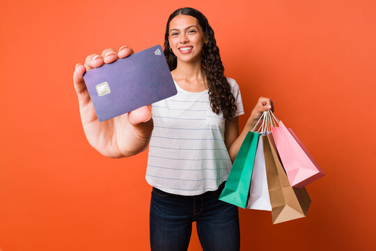 Studio shot of a woman showing her credit card