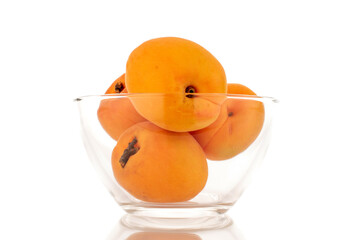 Several ripe sweet apricots with glassware, close-up, isolated on white background.