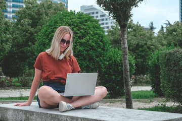 Remote work.Girl freelancer works remotely on the seashore.workation, remote work,WFVH,Van Life...
