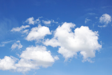 Fototapeta na wymiar Clouds in a bright blue sky in sunlight