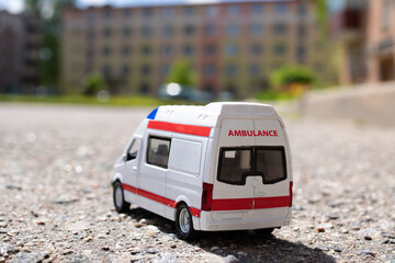 Model of an ambulance car on the background of the city