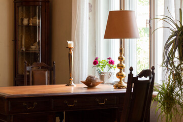 Beautiful vintage dining table with candles and window coverings.