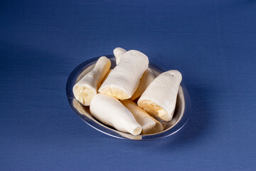 Photo of brazilian food called mandioca aipim cassava, pieces cut from the peeled root