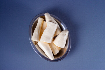 Photo of brazilian food called mandioca aipim cassava, pieces cut from the peeled root
