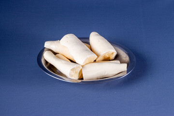 Photo of brazilian food called mandioca aipim cassava, pieces cut from the peeled root