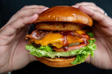 Bacon Cheeseburger In Hands