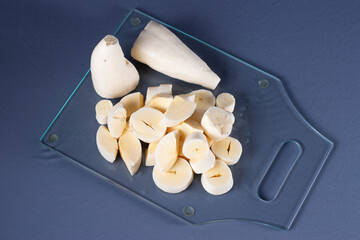 Photo of brazilian food called mandioca aipim cassava, pieces cut from the peeled root