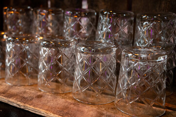 Many clean crystal glasses for water and drinks close up