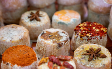 Variety of French soft goat cheese with different toppings, indian, curry, pepper, spicy