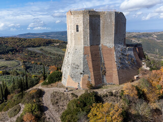 Medieval fortification castle on hilltop and view on hills in Tuscany, Italy