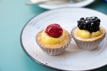 Mini fruit italian cupcakes with fresh berries on board